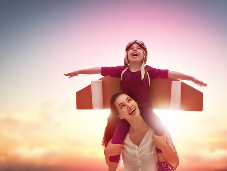 What Does Success Look Like to You? 6 Mother and her child playing together. Child in an astronaut costume plays.