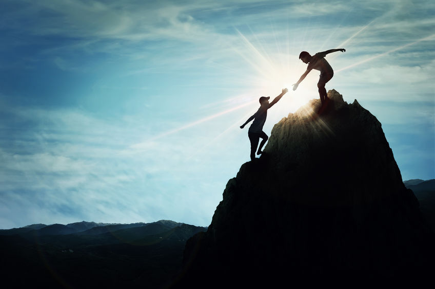 My Mentoring Mantra 5 Silhouette of helping hand between two people climbing a rock, A friendly hand on the high mountain hike. inspirational teamwork.
