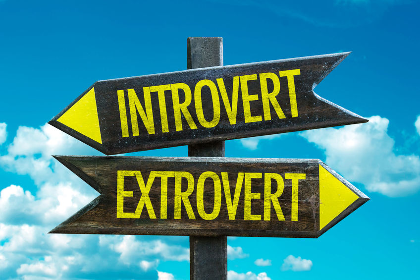 How to Mentor Introverts 4 Directional sign with arrow on clouds and sky background: introvert/extrovert