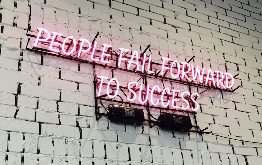 Real Goals in Action 4 Neon sign that says People fail forward to success.