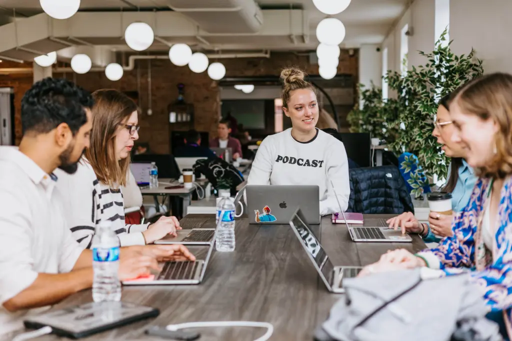 What Are Leadership Skills? (And How to Develop Them) 5 Women at a table developing leadership skills through group sessions.