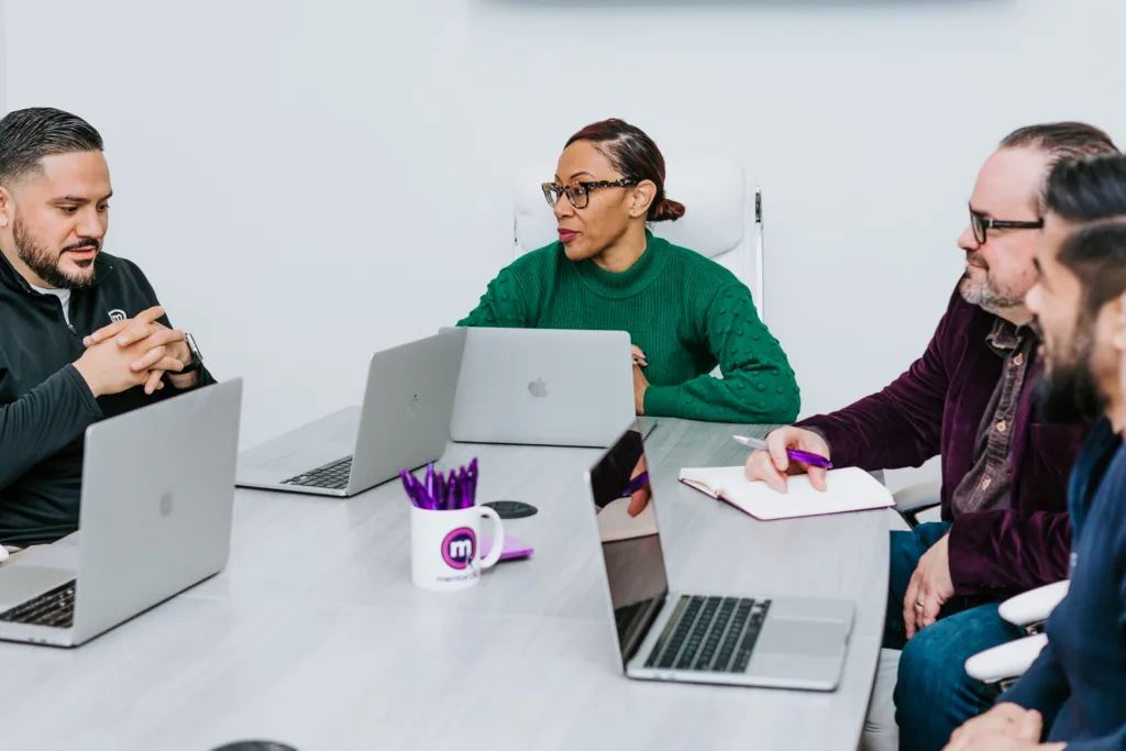 Mentorship Examples: Ideas for Successful Mentoring Program 5 A mentorship example of employees in a meeting room talking.