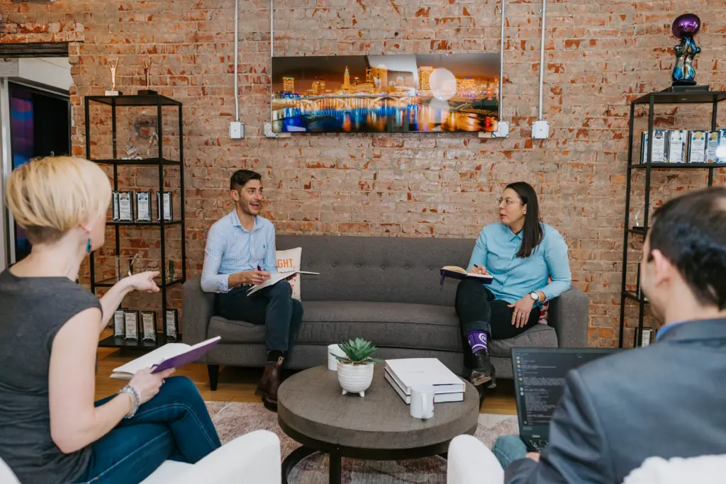 Comprehensive Mentor Training Guide: Boost Mentor Readiness 5 A group of employees in a mentor training session sitting in an office.