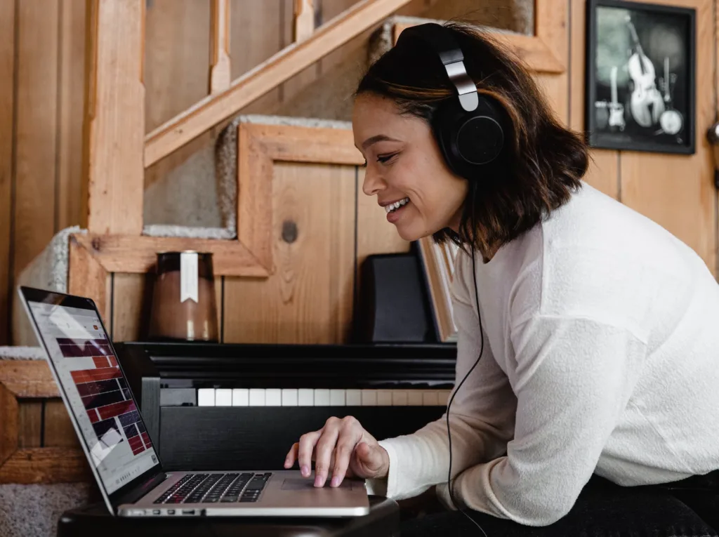 Virtual Mentoring in the Age of Social Distancing 7 A mentor working on their laptop wearing over the ear headphones in their home office.
