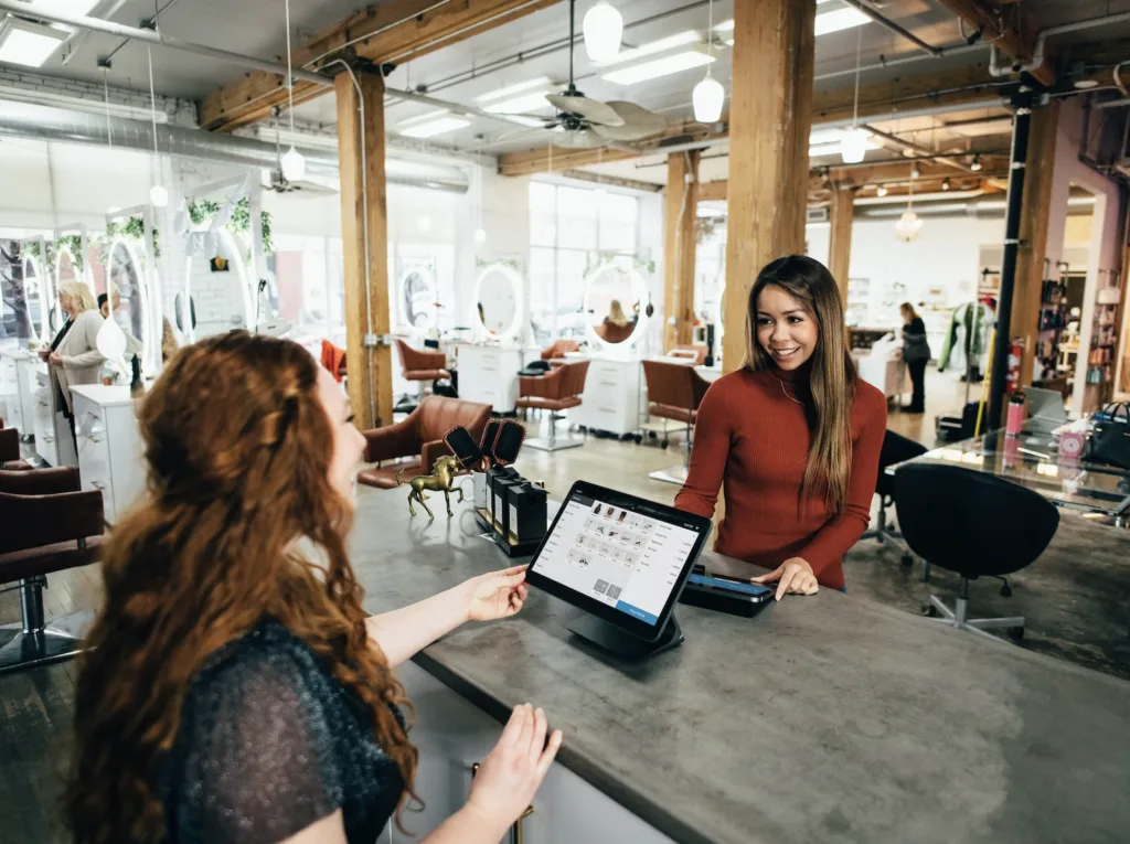 How Do I Run a Successful Mentoring Pilot? 5 A Mentor and Mentee in a meeting sitting at a table in an open office environment.