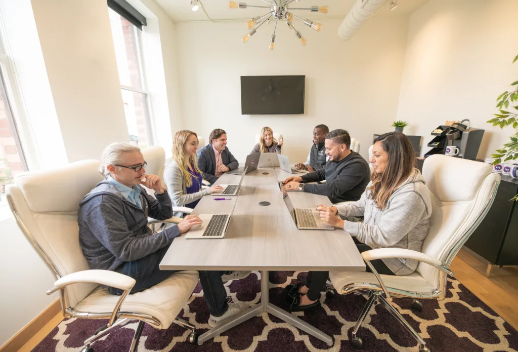 Executive Onboarding: Strategic Priorities and Best Practices for Successful Onboarding 5 Executive onboarding occuring within a board room with executive leadership team present.