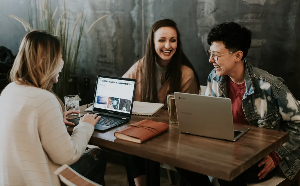 4 Reasons Employees Are Quiet Quitting And How Mentoring Can Prevent It 5 Happy employees who aren't quiet quitting thanks to mentoring programs.
