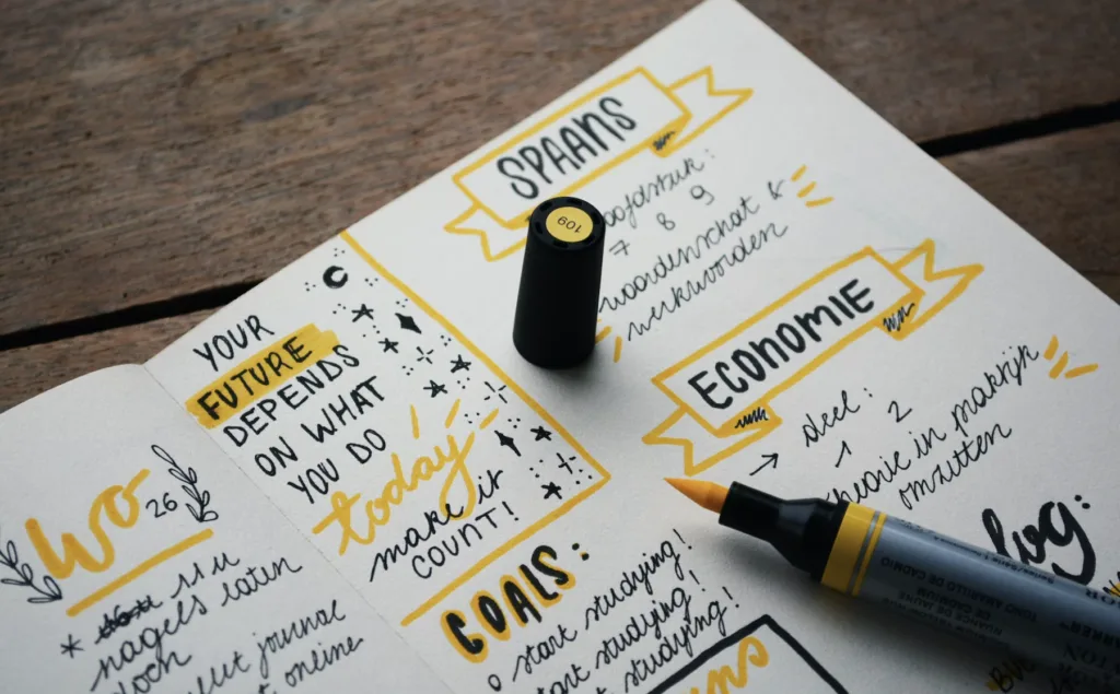 How to Set Long Term Career Goals - And Achieve Them 8 Long term career goals writing down goals in a notebook.