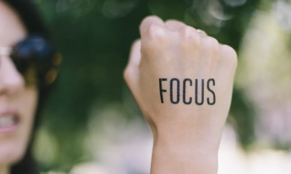 How to Set Long Term Career Goals - And Achieve Them 9 Focus written on a hand to highlight long term career goals and motivation.