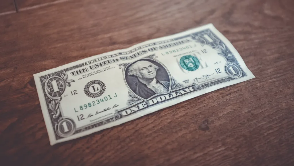 What Are Career Goals? Explanation & 20+ Examples 11 Image of a dollar bill to represent pay raise career goal.