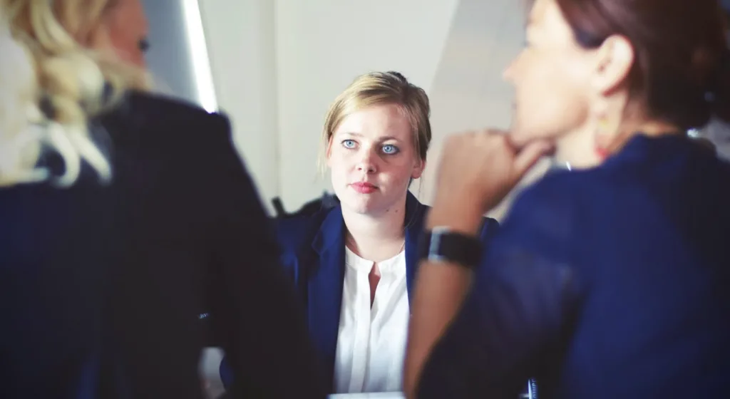 What Is the Purpose of Mentoring Programs? 7 Women on a job interview during employee engagement crisis.
