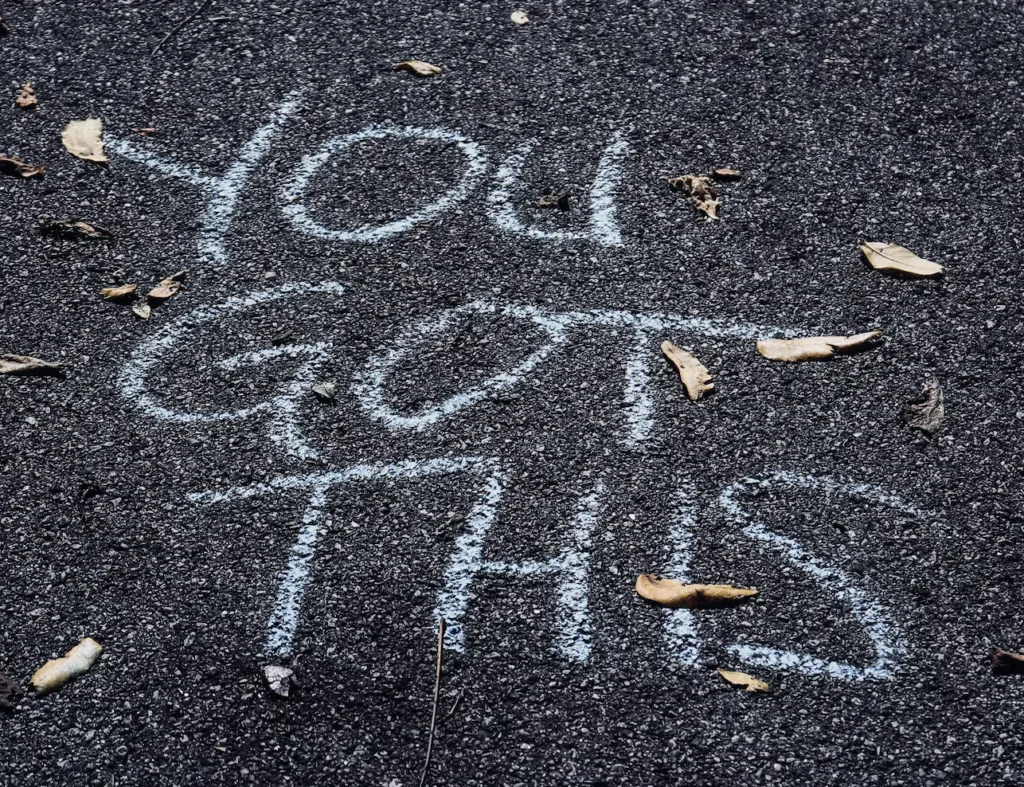 What Does Success Look Like to You? 7 Words written in white chalk on the pavement saying You Got This.